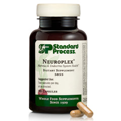 Standard Process Neuroplex bottle on a clean desk, suggesting nervous system support.