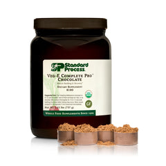Standard Process Veg-E Complete Pro chocolate powder tub close-up for protein shakes.