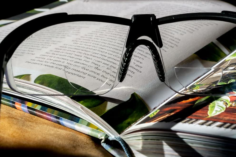 On-the-go reading with StickTite Lenses during a sunny cafe visit.