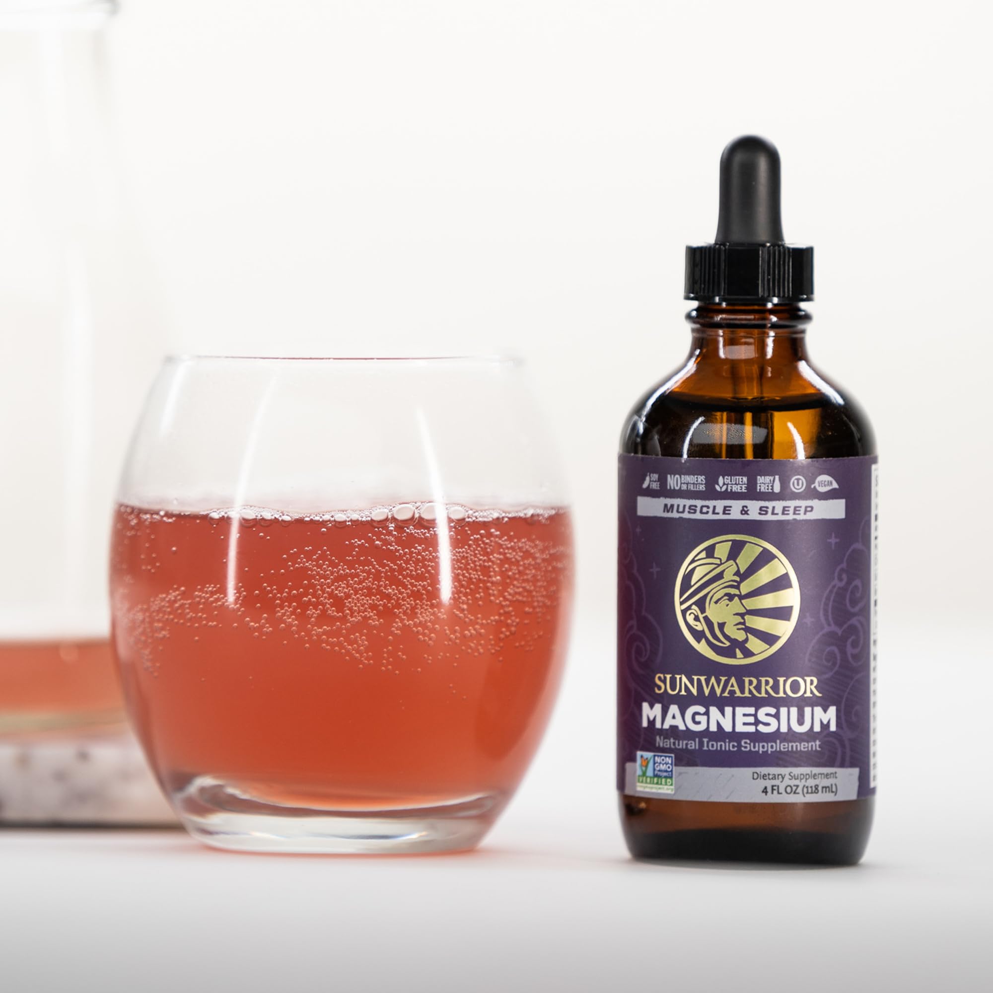 Sunwarrior magnesium bottle with glass shows convenient daily supplement routine