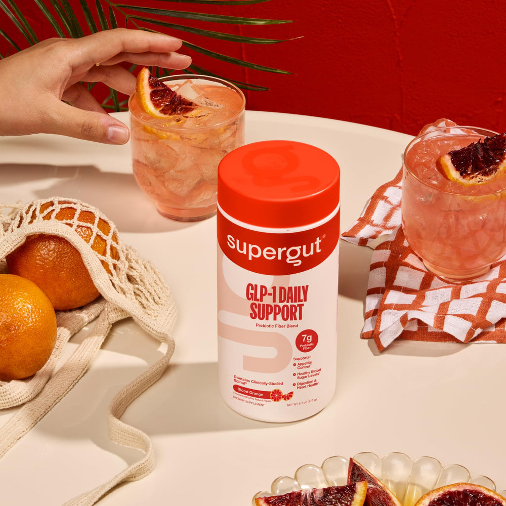 Supergut GLP-1 Daily Support glass of mixed drink with ice and citrus.