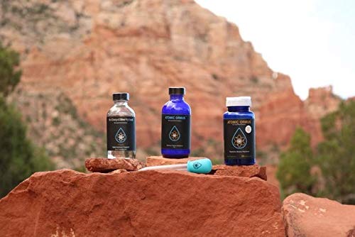 Suspended Solutions Atomic ORMUS bottle beside morning light, ideal for morning routines.