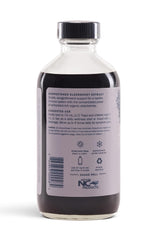 Sweet's Elderberry bottle pour showing convenient adult and kid dosing