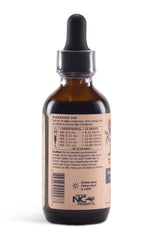 Pouring Sweet's Elderberry Tincture into a glass for daily antioxidant support