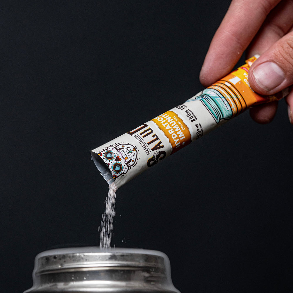 Taste Salud mango drink sachet next to a water bottle for daily hydration.