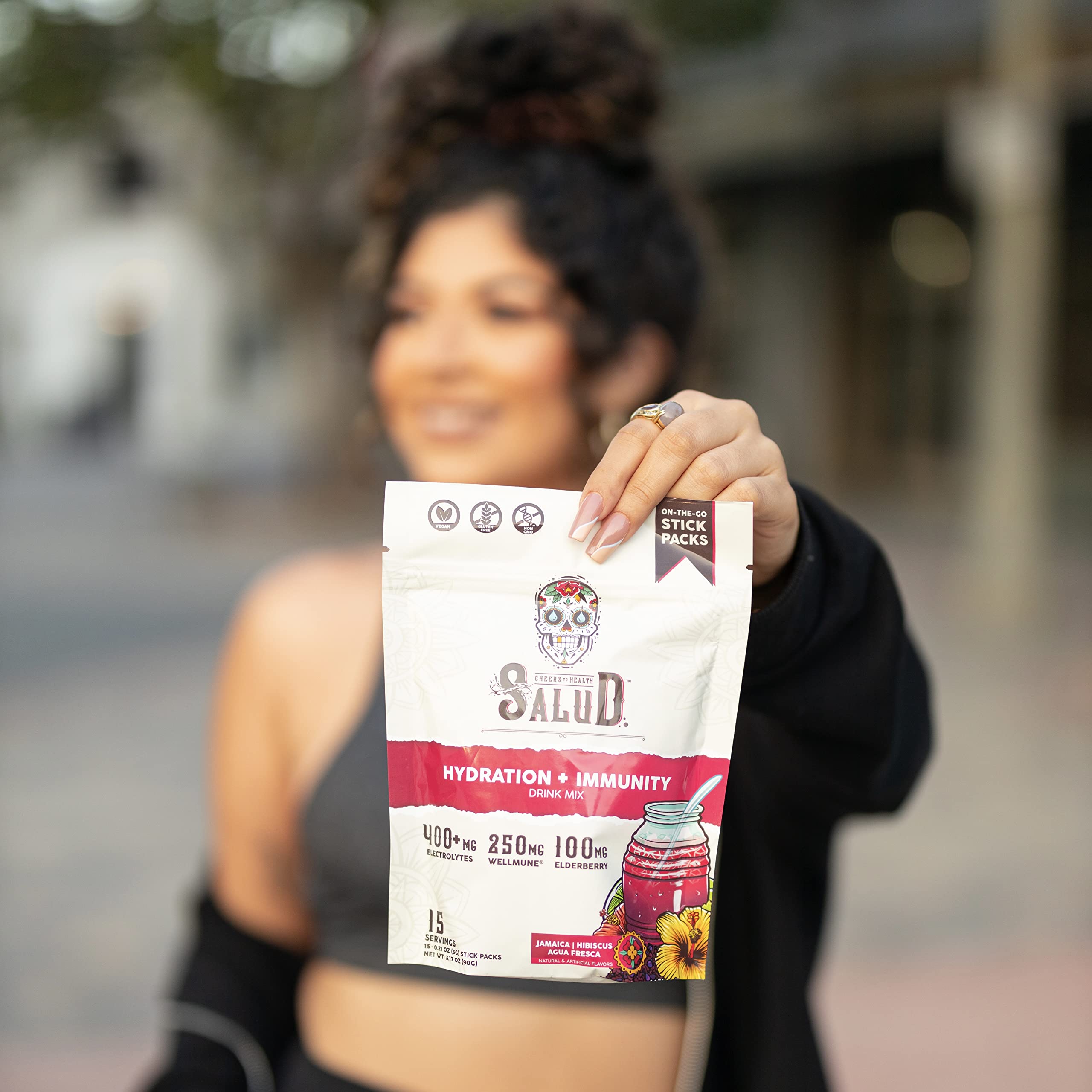 Taste Salud on-the-go stick pack beside a water bottle.