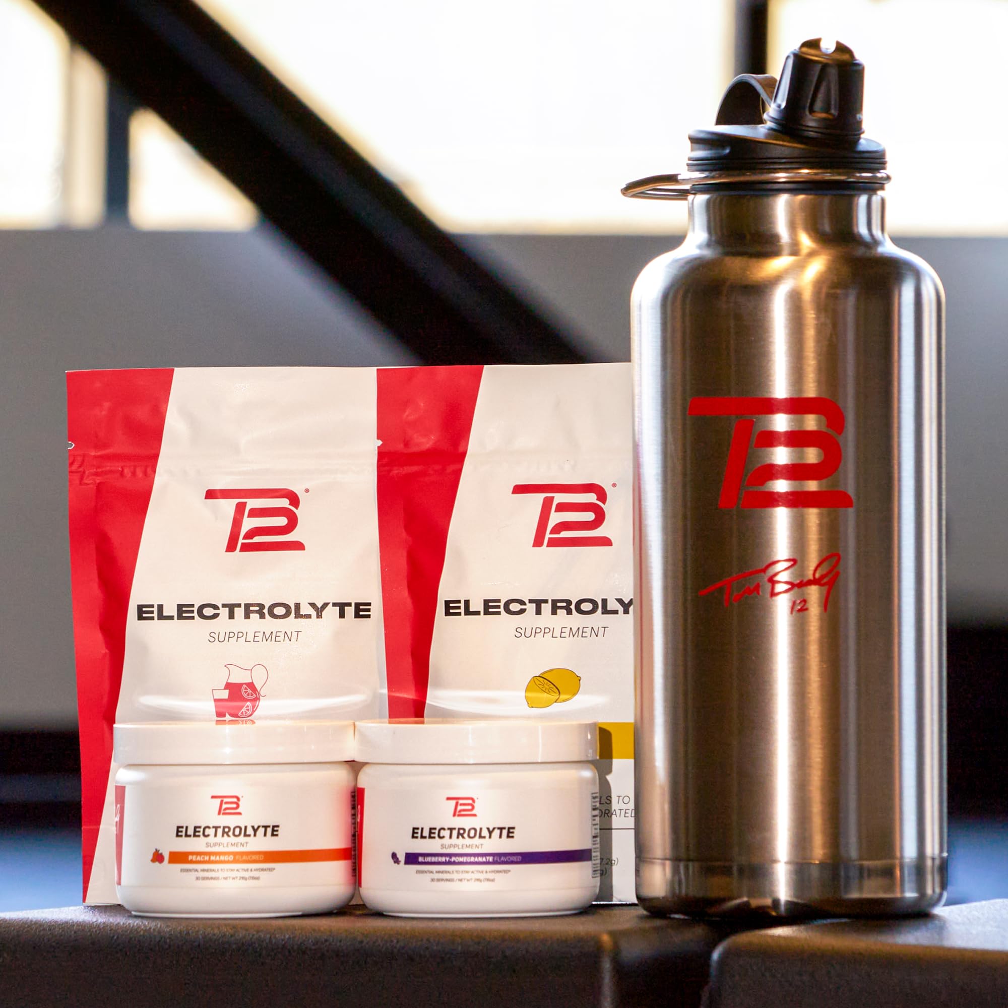 TB12 Electrolyte Powder Fruit Punch serving jar ready for travel hydration
