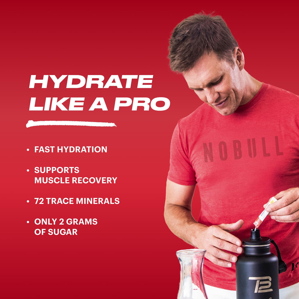 TB12 Electrolyte Powder Fruit Punch shaker bottle ready for workout hydration