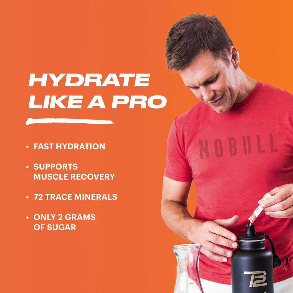 TB12 electrolyte powder poured into a glass of water for fast hydration
