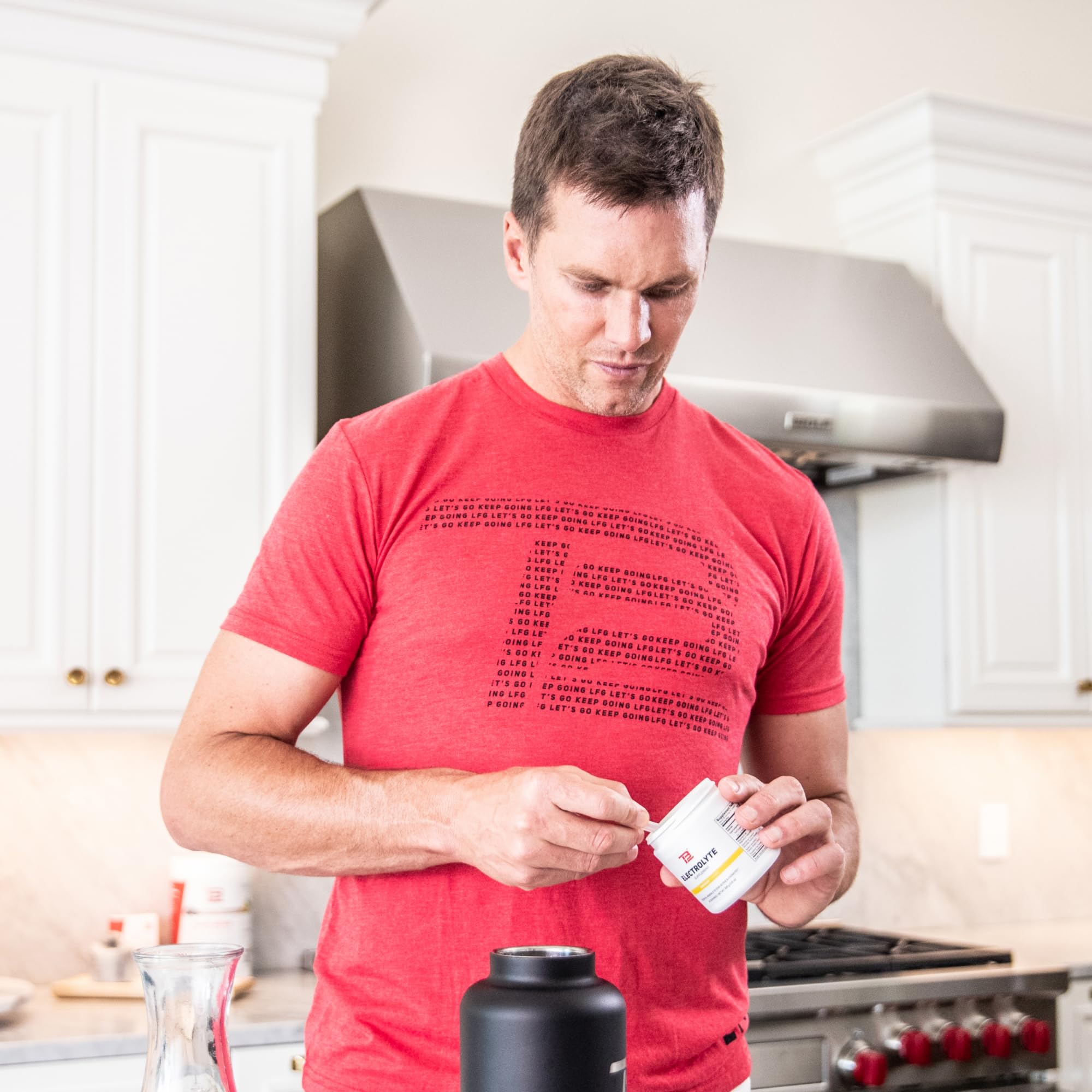 TB12 lemonade flavor mix beside lemon halves for zest and refreshment.
