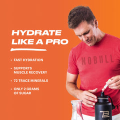 TB12 Electrolytes Peach Mango stickpack mix dissolving in water for refreshing support.