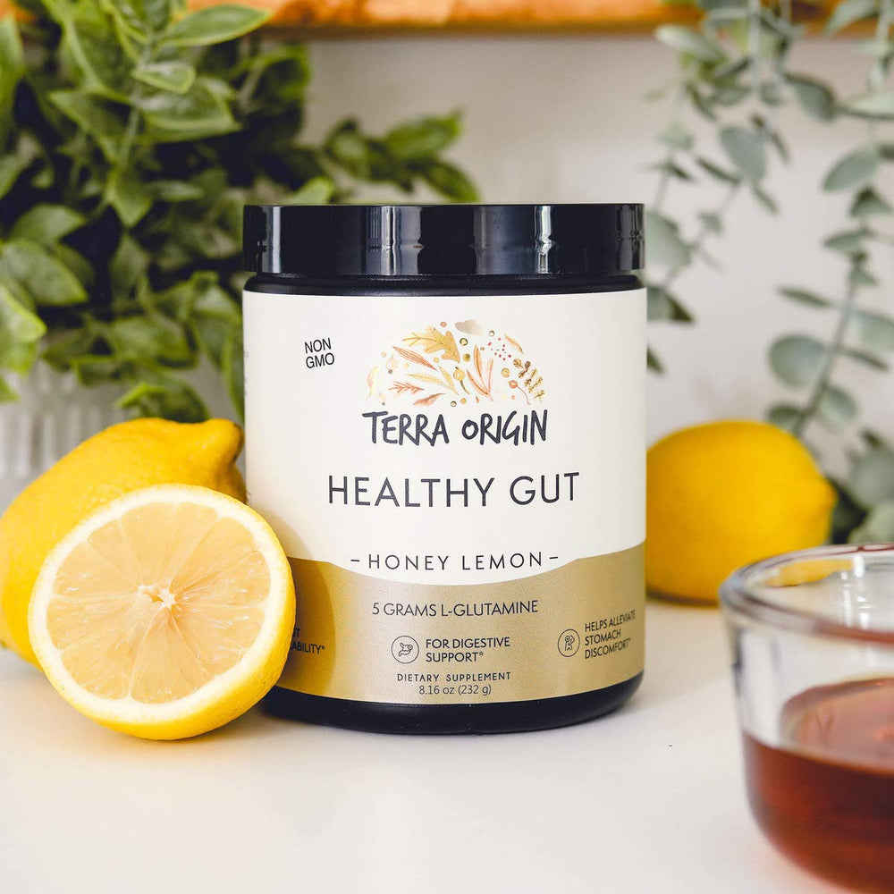 Terra Origin Healthy Gut Powder honey lemon flavor mixed in a glass.