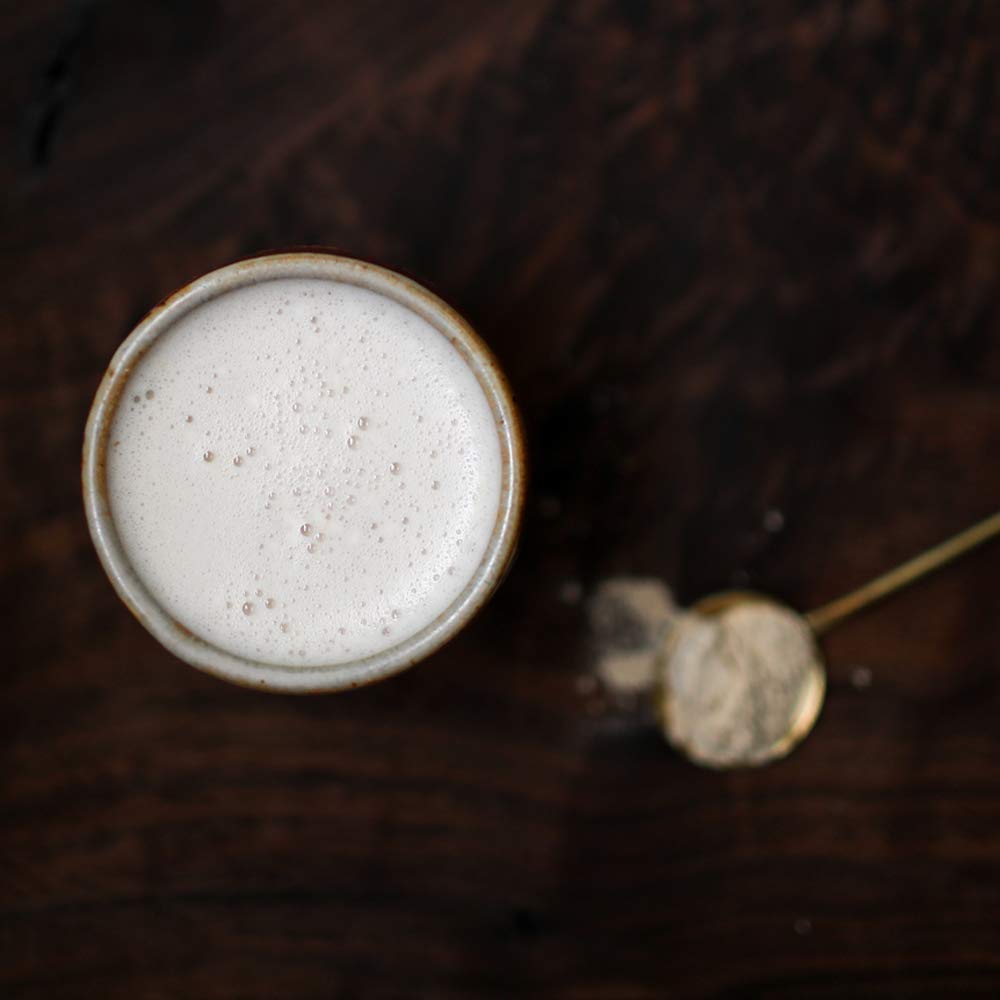 Terrasoul maca powder dissolving in water—versatile beverage addition.
