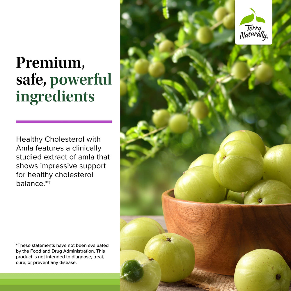 Terry Naturally Healthy Cholesterol with Amla on a counter beside a glass for routine use.