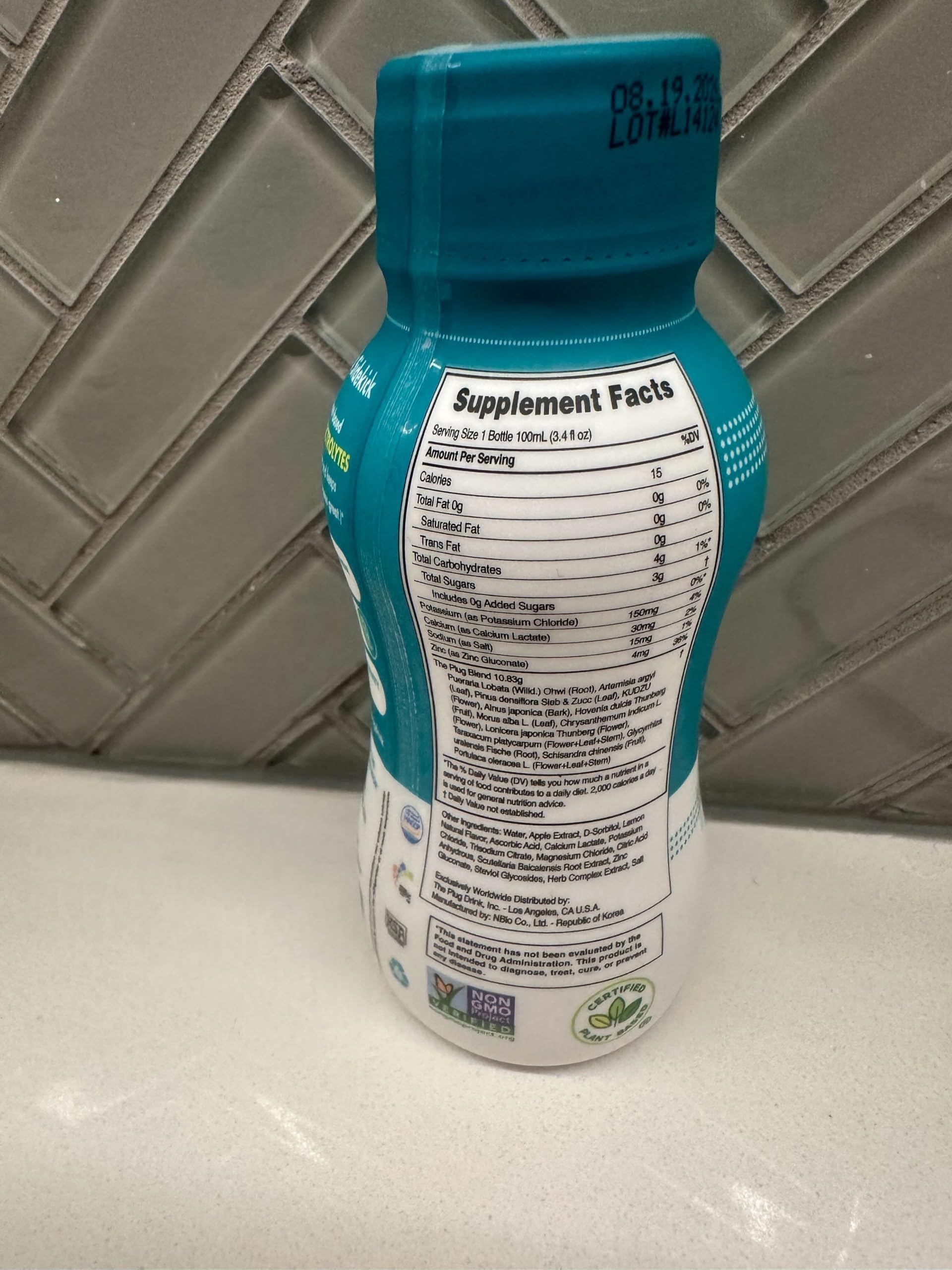 The Plug Liver Cleanse bottle held for on-the-go hydration.
