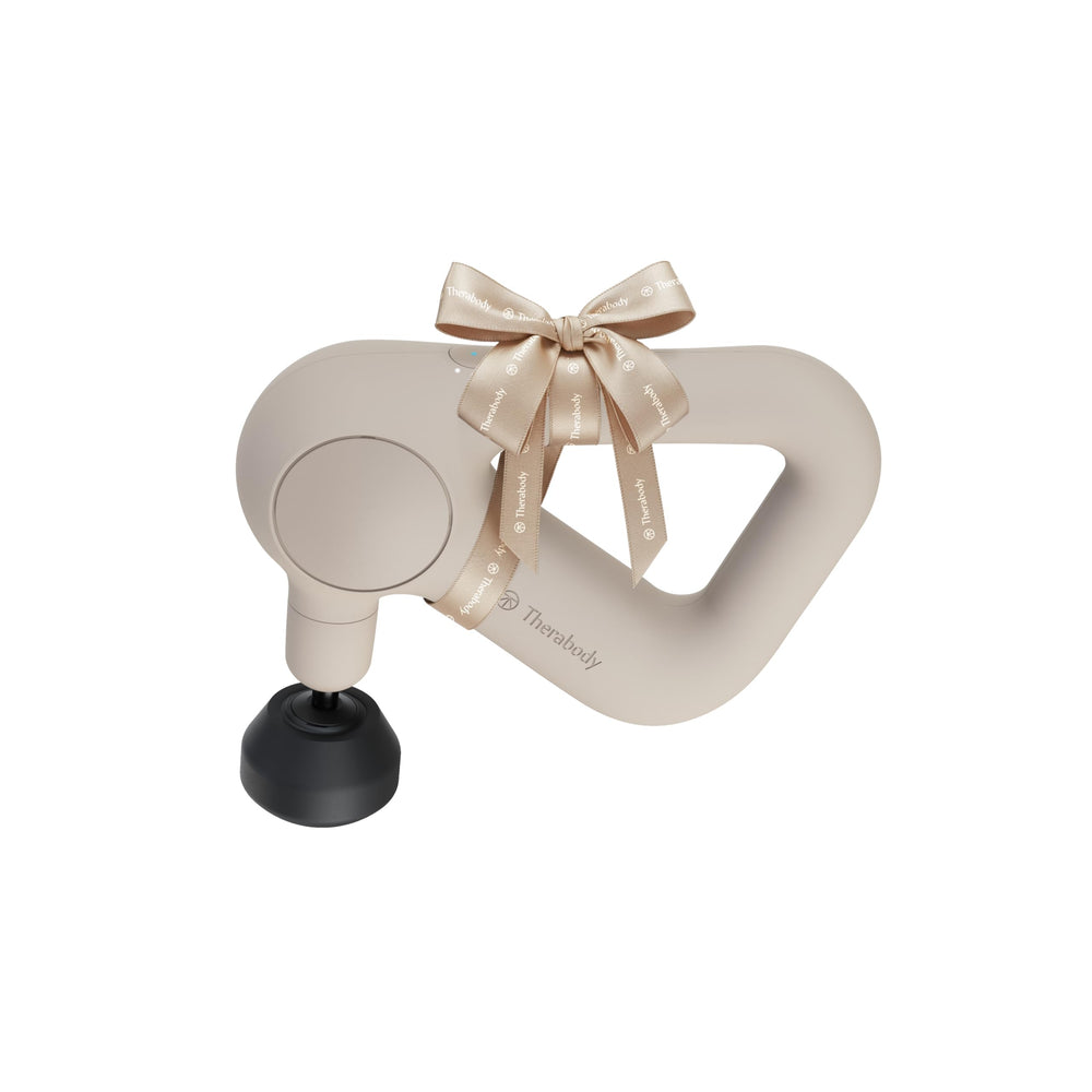 TheraGun Relief handheld massage gun in sand color for quick muscle relief.