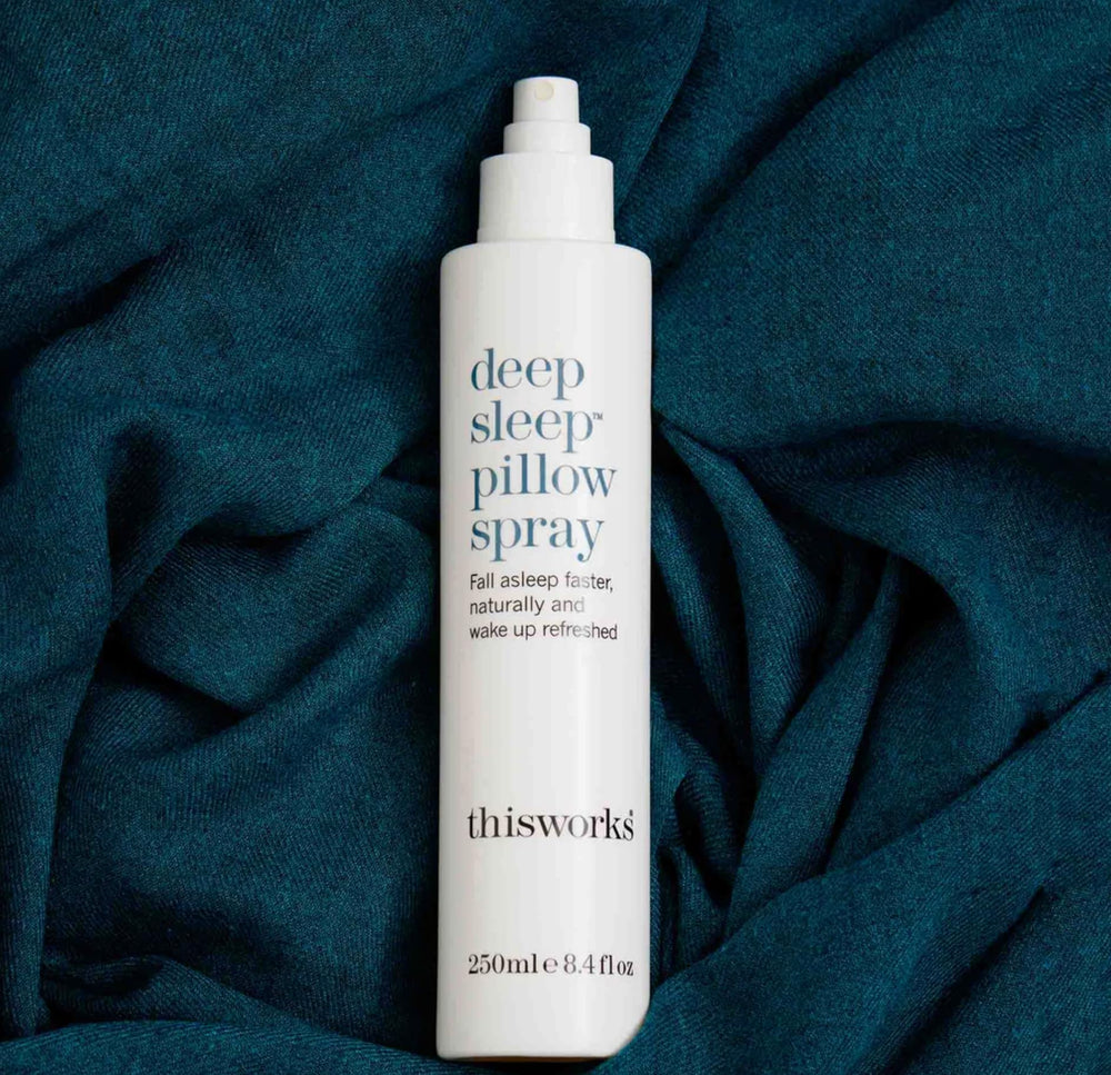 Mist dispersing from THISWORKS Deep Sleep Pillow Spray onto a pillow