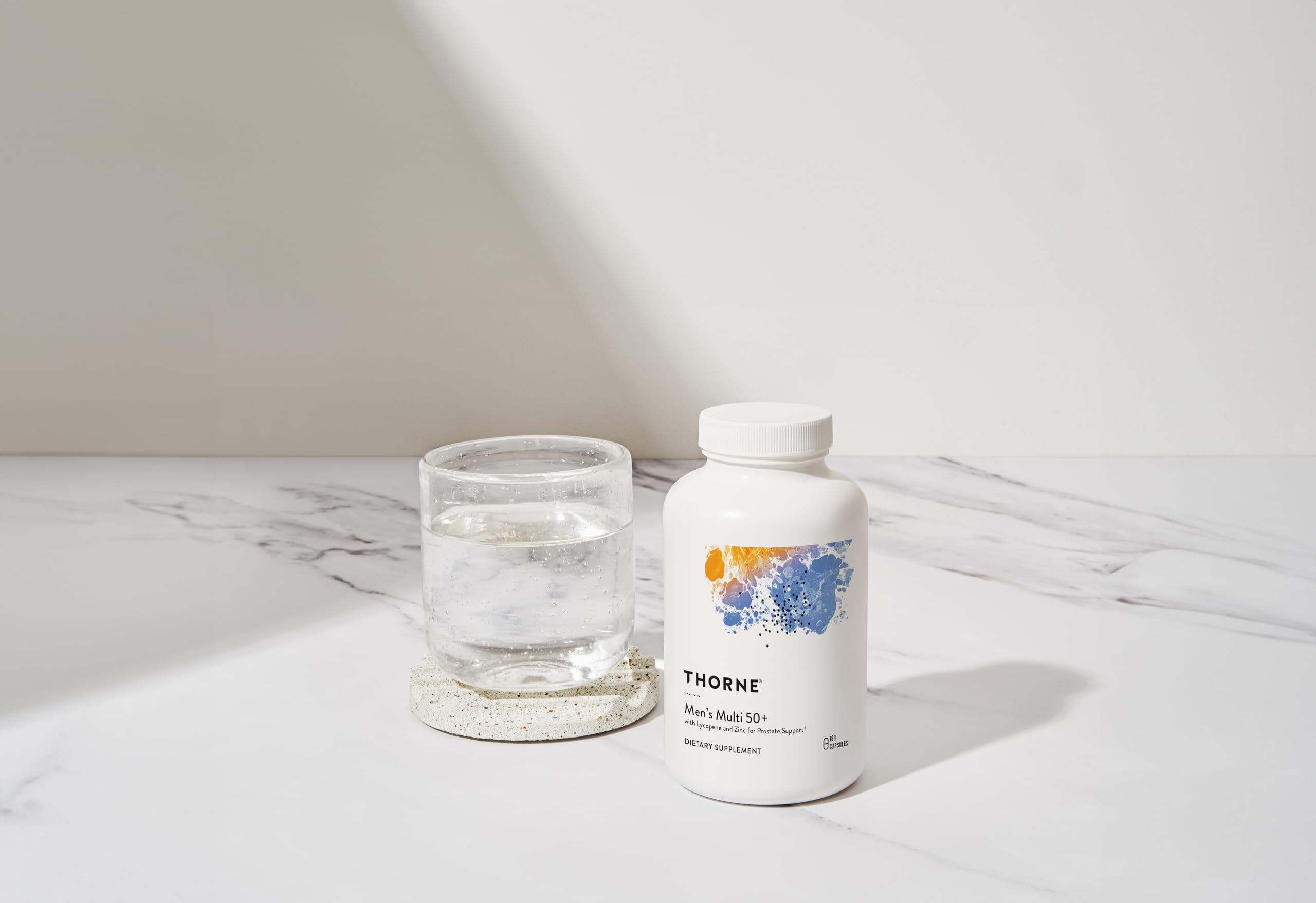 Thorne Men's Multi 50+ bottle on morning table for immune support and energy.