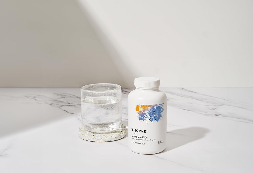 Thorne Men's Multi 50+ bottle on morning table for immune support and energy.