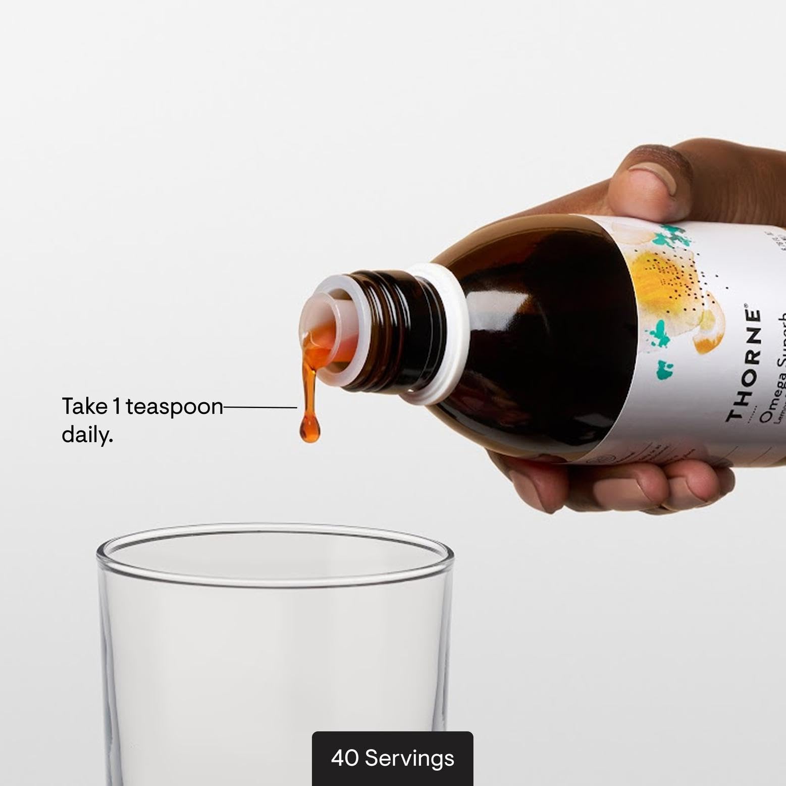 Clear THORNE Omega Superb liquid being poured for serving.