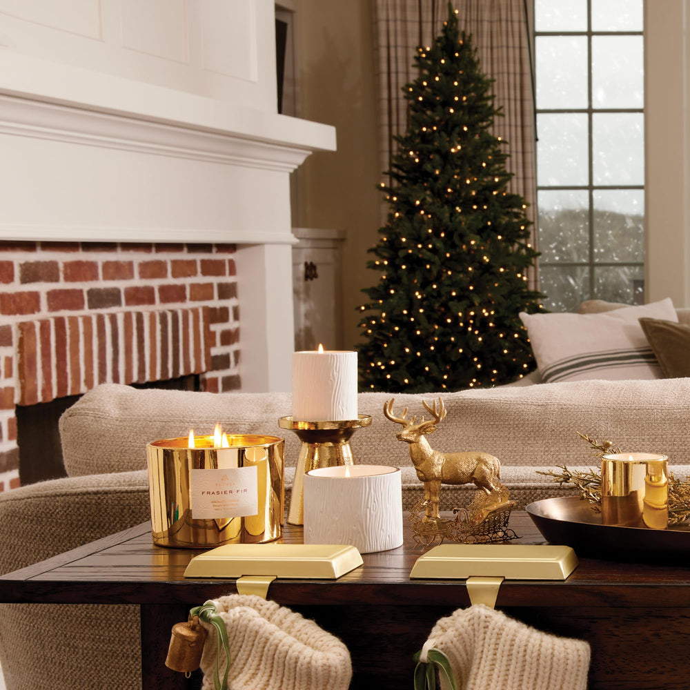 Thymes Frasier Fir candle with 24K gold rim adds luxury to decor.