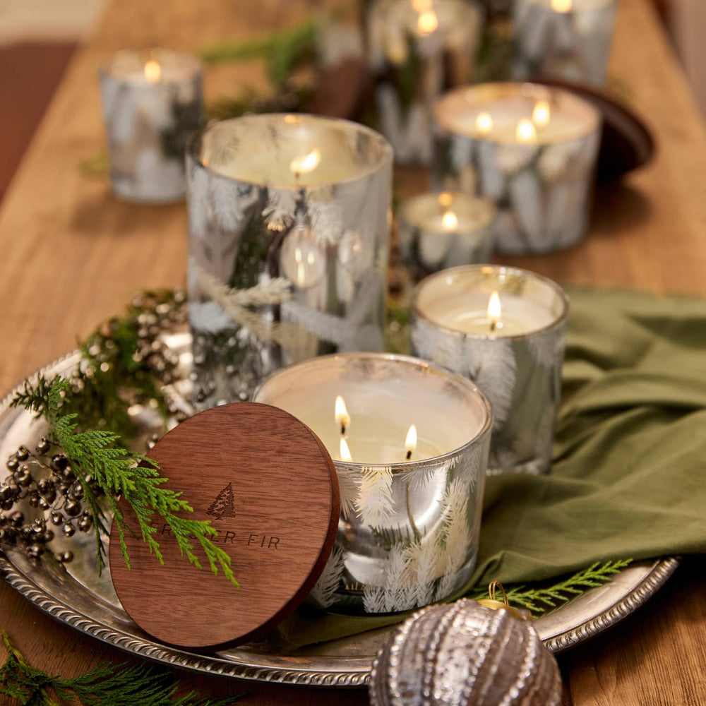 Silver pine needle luminary reflecting soft candlelight