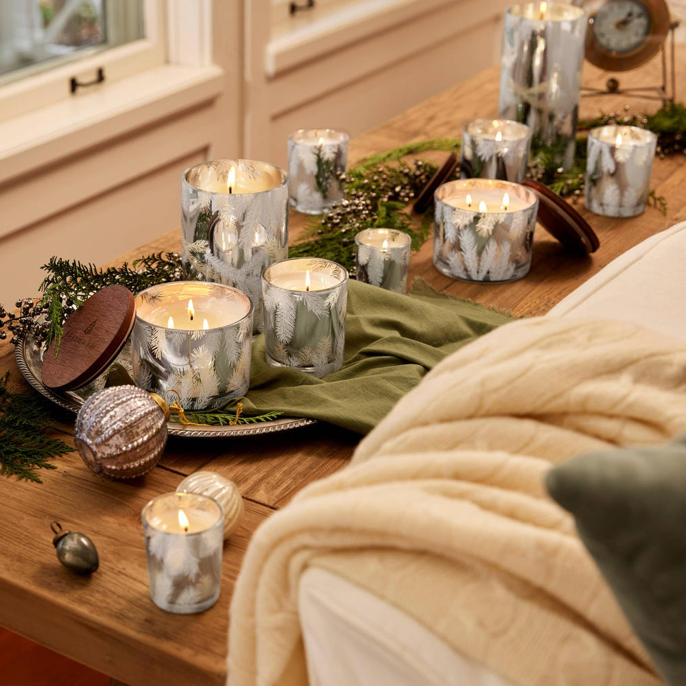 Luxurious silver luminary with pine needle motif elevates decor