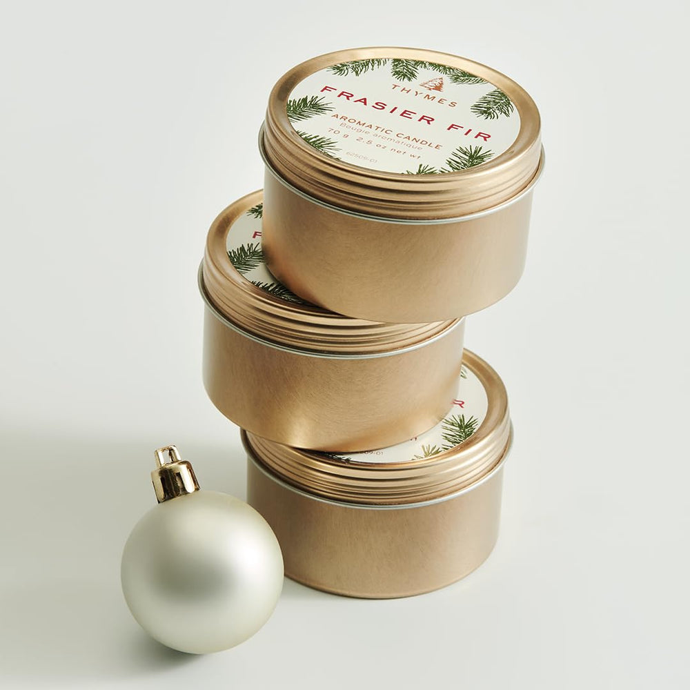 Thymes Travel Tin Frasier Fir burn glow suggests cozy ambiance.