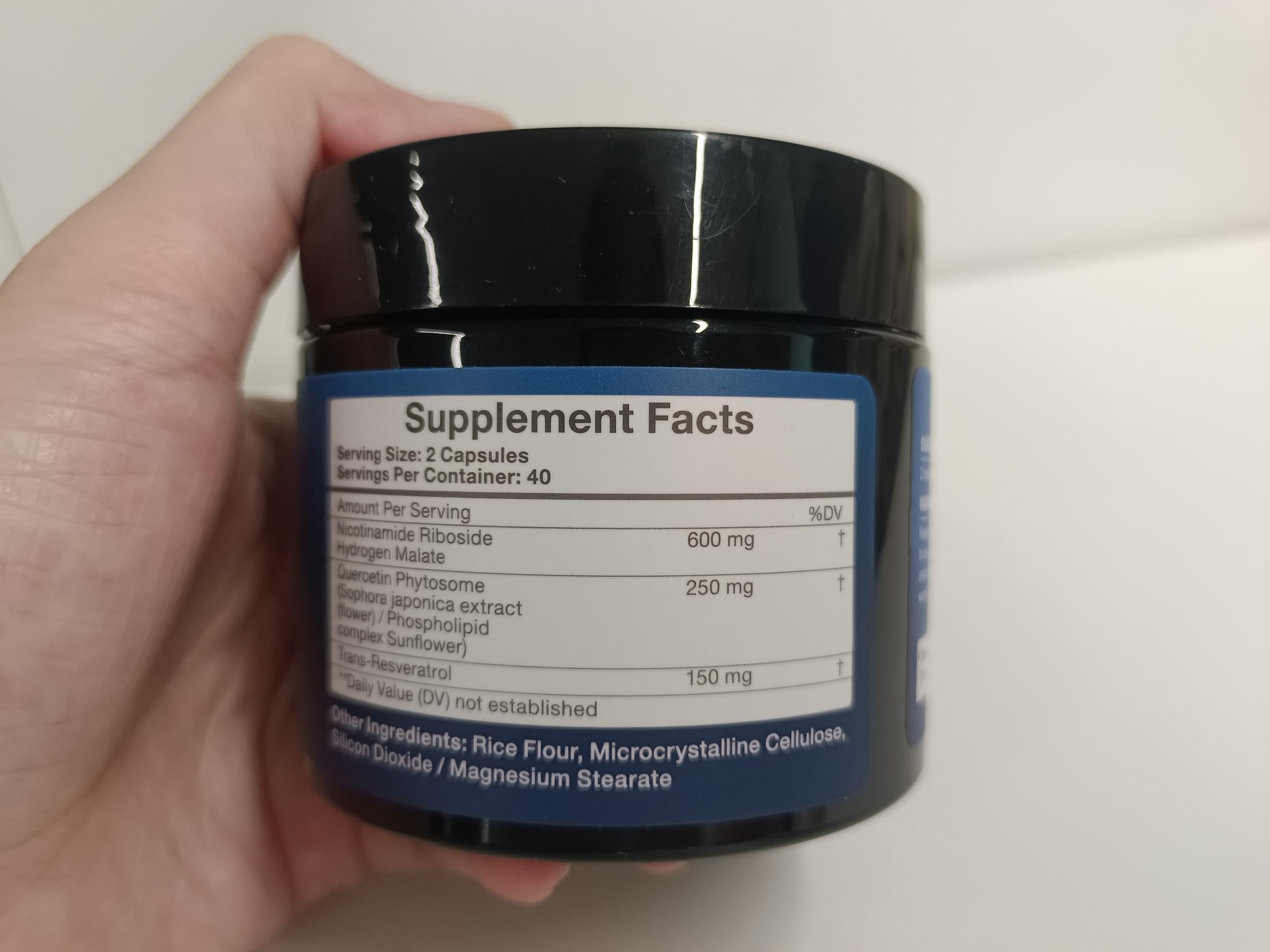 TOPCAPAK NAD+ 1000mg daily-use setup showing a user taking a capsule