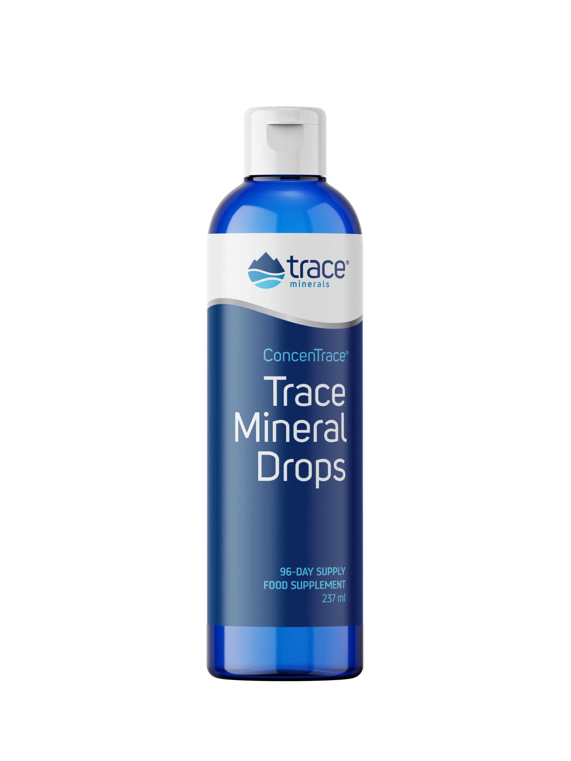 Trace Minerals Concentrace mineral drops bottle beside a glass of water for daily mineral support.