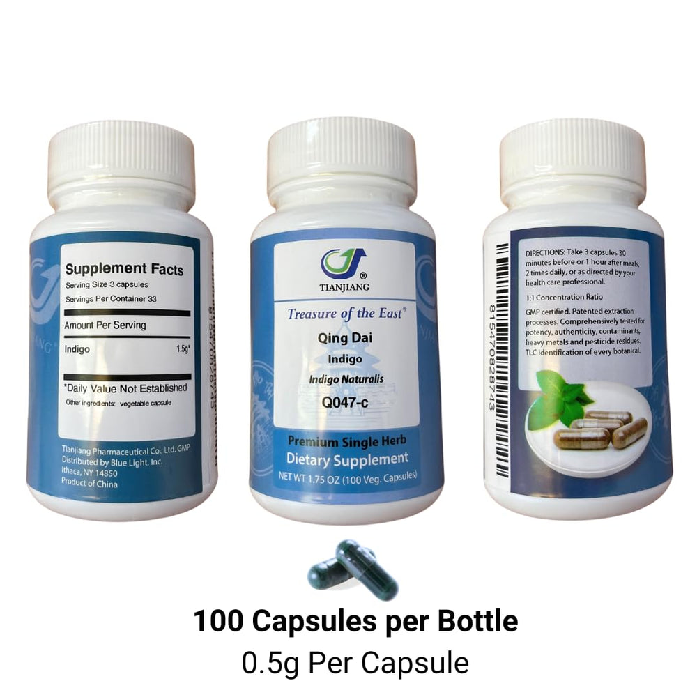 Indigo Qing Dai capsules in hand show convenient size for daily use.