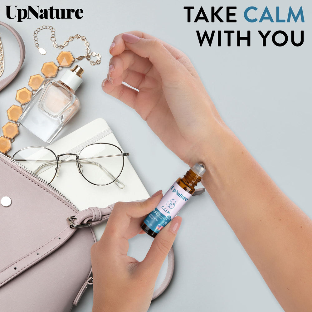 UpNature Calm travel-friendly roll-on shown beside airplane tray