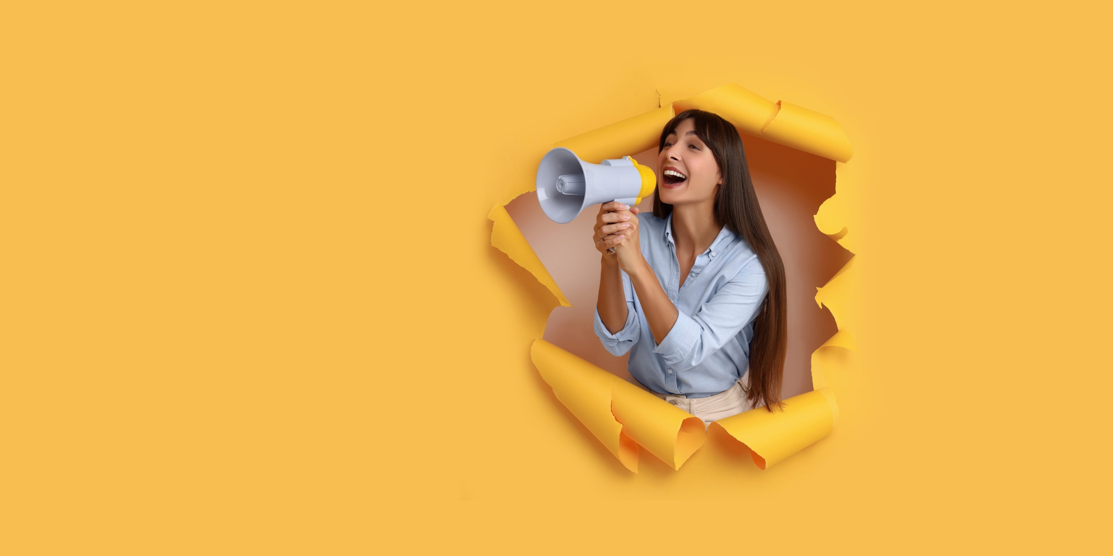 Woman holding a megaphone emerging from a yellow paper background