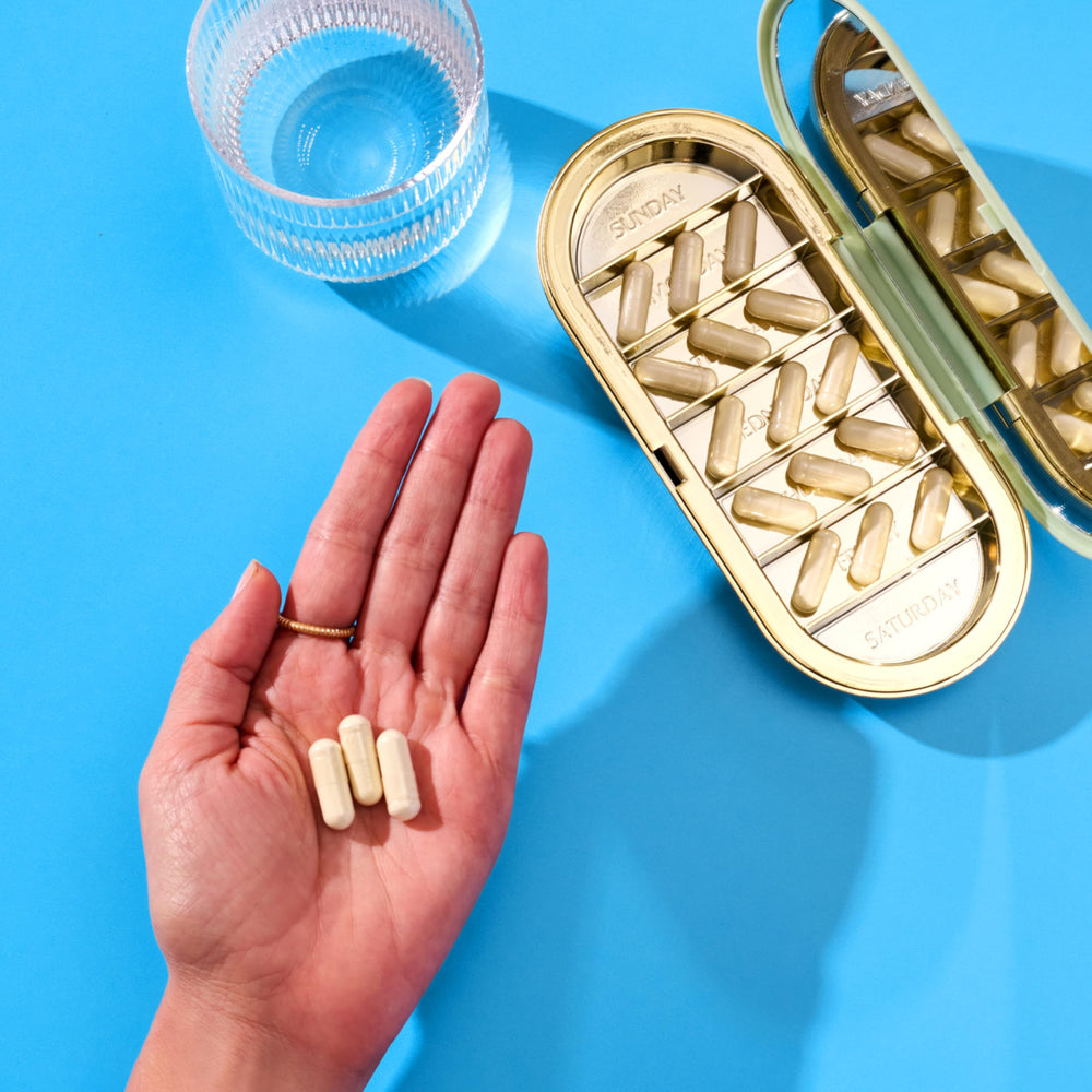 Vital Proteins bovine colostrum capsules in hand illustrating on the go routine