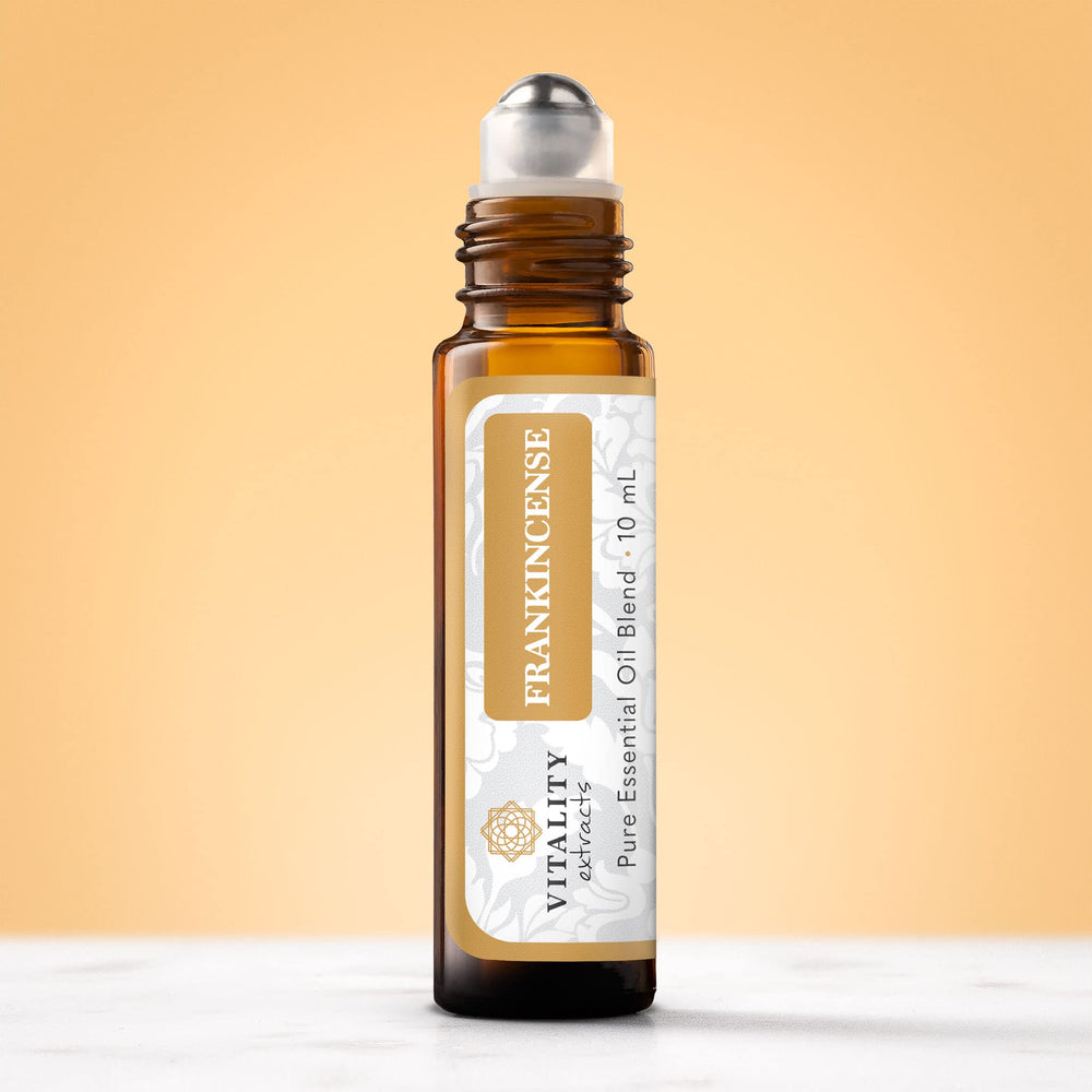 Vitality Frankincense roll-on in hand ready for pulse-point application