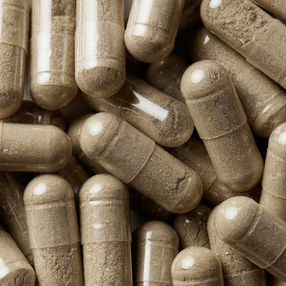 Close-up of WELLBEL Women capsules ready to take.