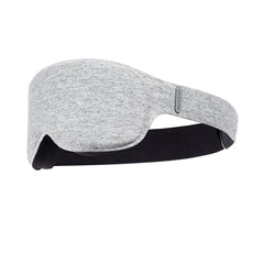 Whoop Restorative Sleep Mask on pillow shows premium light-blocking comfort.