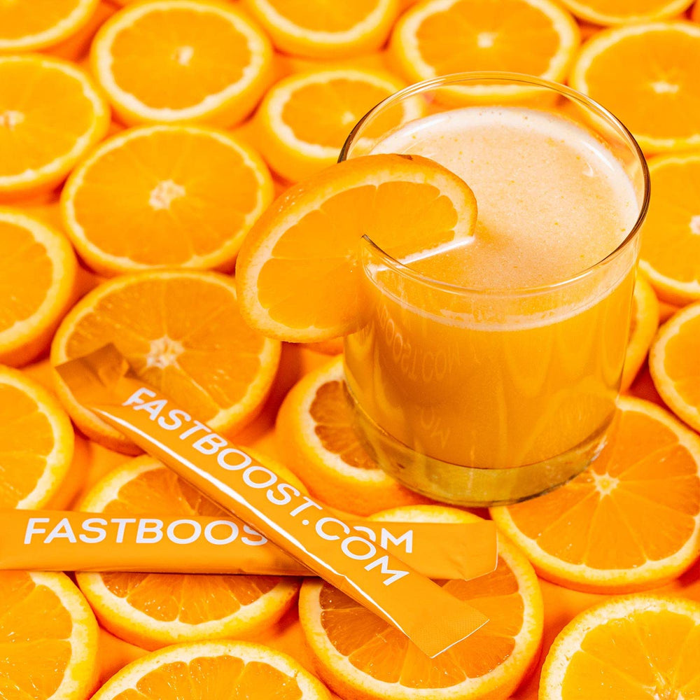 Pouring orange powder into a glass of cold water for hydration