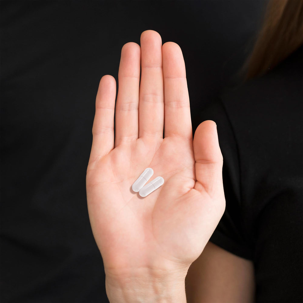 Xtravit capsules with a glass of water for easy administration