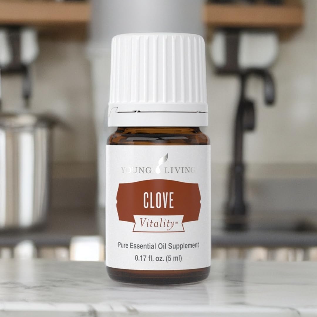 Spice rack featuring Young Living Clove Vitality for enhanced cooking.