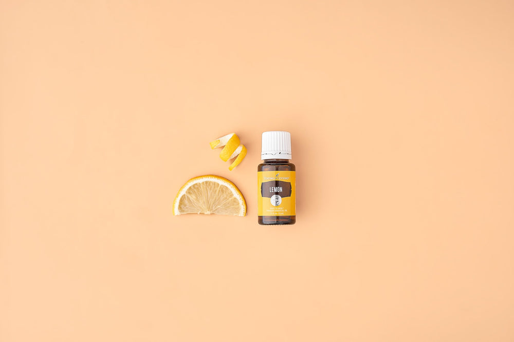 Young Living Lemon bottle held in hand showing convenient 15 ml size