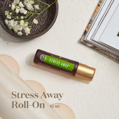 Applying Young Living Stress Away Roll-On to the wrist for quick relaxation.