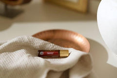 Young Living Thieves Roll-On applicator close-up for quick, mess-free application.