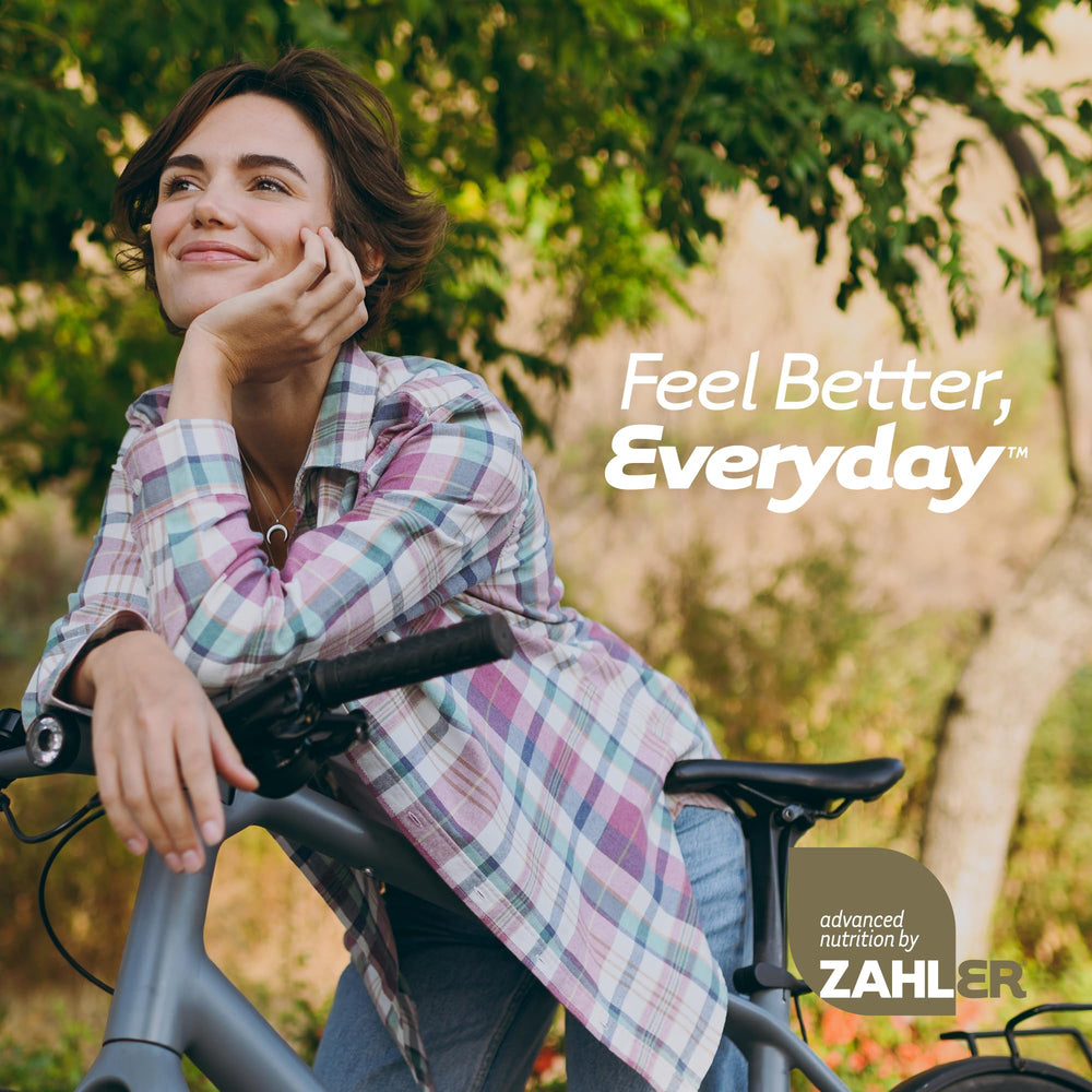 Zahler RevolUTion woman taking capsules with a glass of water.